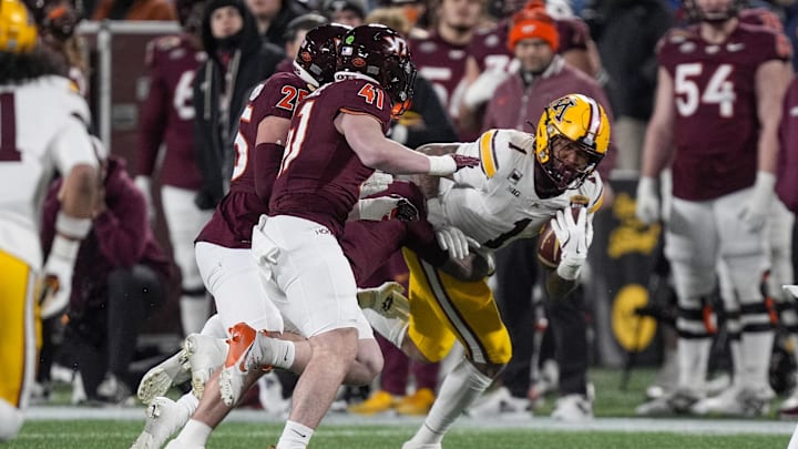 Jan 3, 2025; Charlotte, NC, USA; Minnesota Golden Gophers running back Darius Taylor (1) runs for yardage against the Virginia Tech Hokies during the second quarter at the Duke’s Mayo Bowl at Bank of America Stadium. Mandatory Credit: Jim Dedmon-Imagn Images