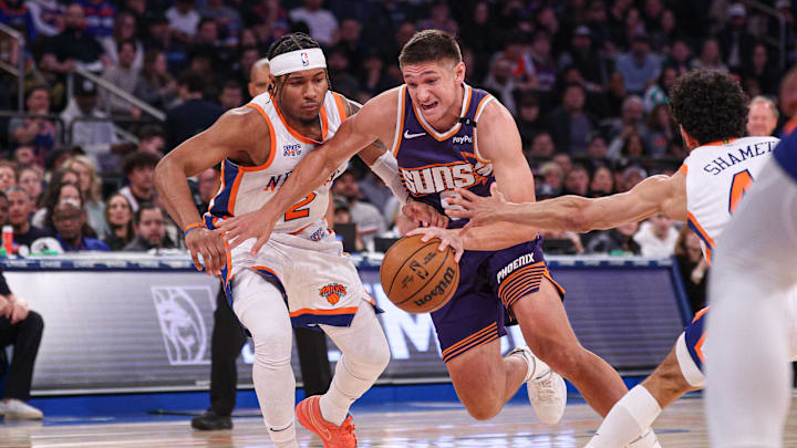 Phoenix Suns guard Grayson Allen dribbles against New York Knicks guard Miles McBride. Mandatory Credit: Vincent Carchietta-Imagn Images