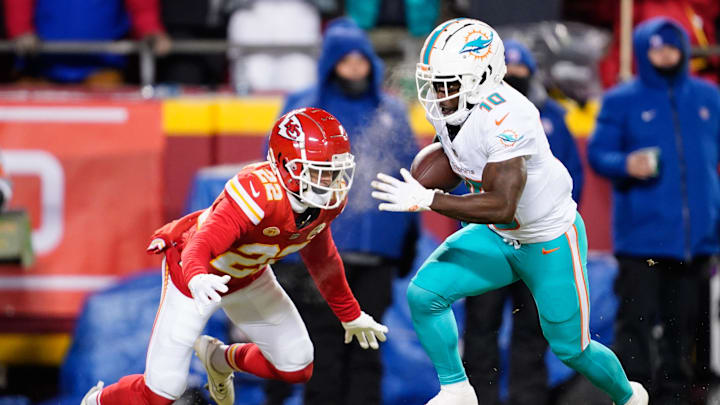 Jan 13, 2024; Kansas City, Missouri, USA; Miami Dolphins wide receiver Tyreek Hill (10) runs the ball ahead of Kansas City Chiefs cornerback Trent McDuffie (22) during the first half of the 2024 AFC wild card game at GEHA Field at Arrowhead Stadium. Mandatory Credit: Jay Biggerstaff-Imagn Images