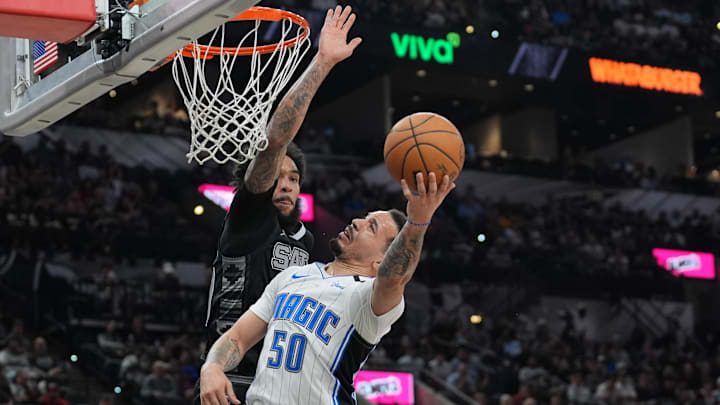 Orlando Magic guard Cole Anthony puts up a shot in front of San Antonio Spurs forward Julian Champagnie.