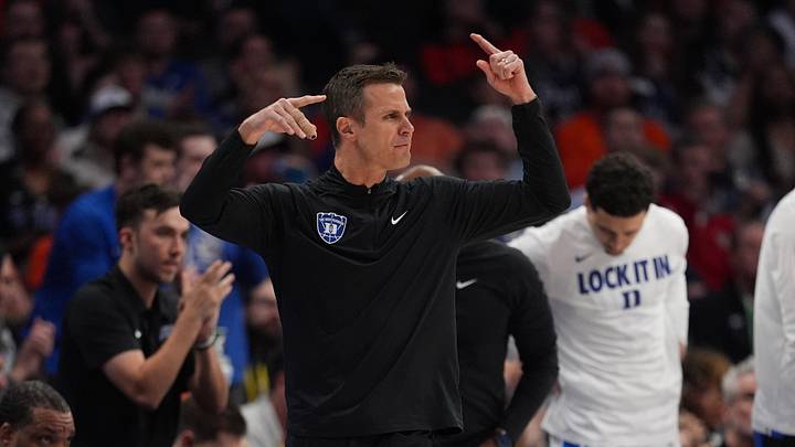 Mar 13, 2026; Charlotte, NC, USA; Duke Blue Devils head coach Jon Scheyer signals to his team during the first half against the Clemson Tigers at Spectrum Center. Mandatory Credit: Jim Dedmon-Imagn Images
