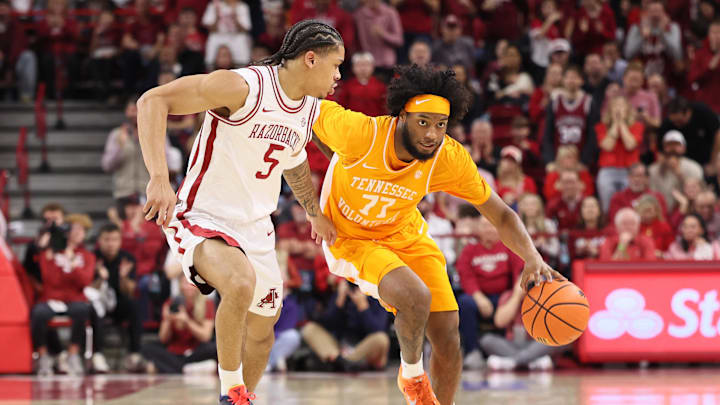 Jan 3, 2026; Fayetteville, Arkansas, USA; Tennessee Volunteers guard Amaree Abram (77) drives against Arkansas Razorbacks guard Darius Acuff Jr (5) during the first half at Bud Walton Arena. Mandatory Credit: Nelson Chenault-Imagn Images