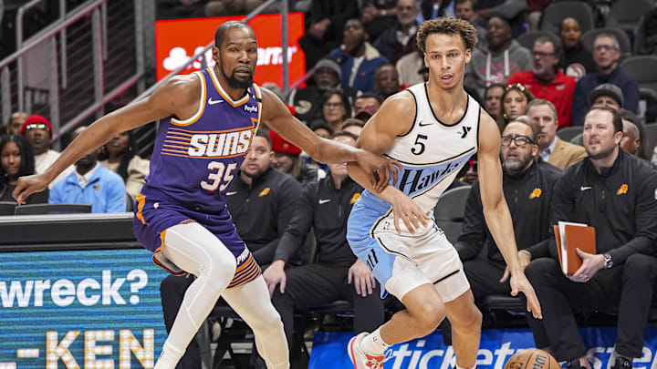 Jan 14, 2025; Atlanta, Georgia, USA; Atlanta Hawks guard Dyson Daniels (5) dribbles defended by Phoenix Suns forward Kevin Durant (35) during the first half at State Farm Arena. Mandatory Credit: Dale Zanine-Imagn Images