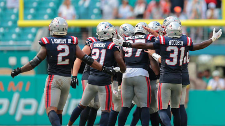 Sep 14, 2025; Miami Gardens, Florida, USA; New England Patriots defensive end Milton Williams (97) celebrates with teammates after sacking Miami Dolphins quarterback Tua Tagovailoa (1) during the fourth quarter at Hard Rock Stadium. Mandatory Credit: Sam Navarro-Imagn Images