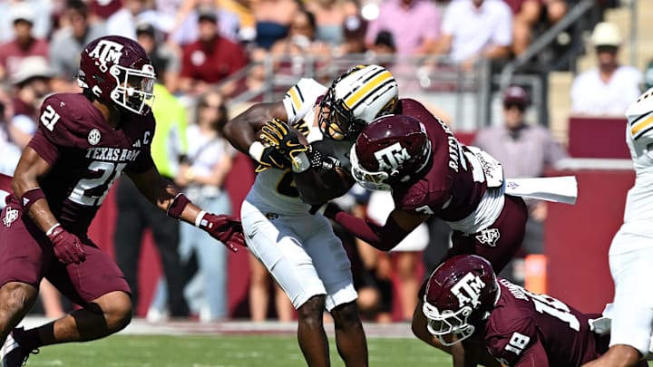Oct 5, 2024; College Station, Texas, USA; Texas A&M Aggies defensive back Marcus Ratcliffe (3) tackles Missouri Tigers running back Nate Noel (8) in the first quarter at Kyle Field. Mandatory Credit: Maria Lysaker-Imagn Images. 
