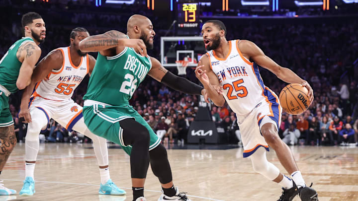 Feb 8, 2025; New York, New York, USA; New York Knicks forward Mikal Bridges (25) looks to drive past Boston Celtics forward Xavier Tillman (26) in the first quarter at Madison Square Garden. Mandatory Credit: Wendell Cruz-Imagn Images