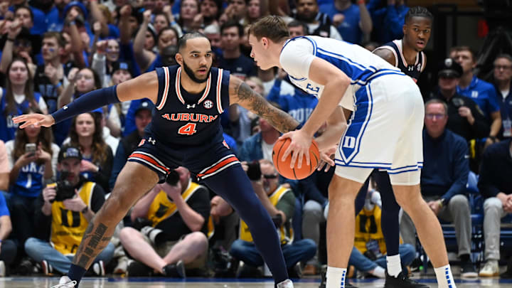 Dec 4, 2024; Durham, North Carolina, USA; Duke Blue Devils forward Cooper Flagg (2) controls the ball in front of Auburn Tigers center Johni Broome (4) during the first half at Cameron Indoor Stadium. Mandatory Credit: Rob Kinnan-Imagn Images