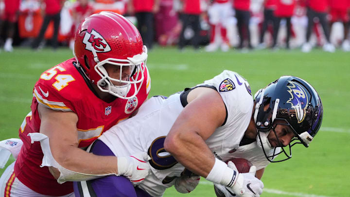 Sep 28, 2025; Kansas City, Missouri, USA; Baltimore Ravens wide receiver LaJohntay Wester (83) makes a catch as Kansas City Chiefs linebacker Leo Chenal (54) tackles during the fourth quarter at GEHA Field at Arrowhead Stadium. Mandatory Credit: Denny Medley-Imagn Images