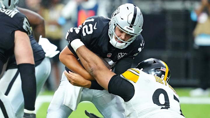 Oct 13, 2024; Paradise, Nevada, USA; Pittsburgh Steelers defensive tackle Cameron Heyward (97) sacks Las Vegas Raiders quarterback Aidan O'Connell (12) during the third quarter at Allegiant Stadium. Mandatory Credit: Stephen R. Sylvanie-Imagn Images