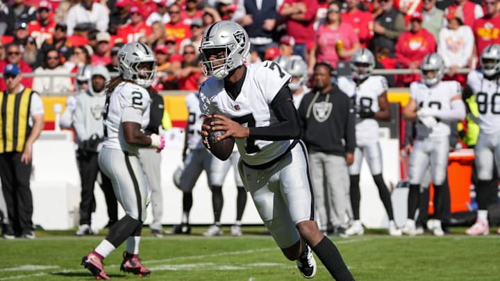 Oct 19, 2025; Kansas City, Missouri, USA; Las Vegas Raiders quarterback Geno Smith (7) looks to pass the ball against the Kansas City Chiefs during the third quarter of the game at GEHA Field at Arrowhead Stadium. Mandatory Credit: Denny Medley-Imagn Images