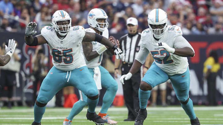 Dec 15, 2024; Houston, Texas, USA; Miami Dolphins guard Robert Jones (65) and offensive tackle Patrick Paul (52) in pass protection for quarterback Tua Tagovailoa (1) during the game against the Houston Texans at NRG Stadium.