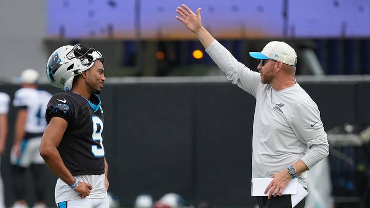 Carolina Panthers quarterback Bryce Young (9) talks with a coach during training camp Carolina Panthers quarterback Bryce Young (9) talks with a coach during training camp