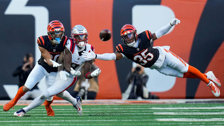 Nov 23, 2025; Cincinnati, Ohio, USA; Cincinnati Bengals cornerback Jalen Davis (35) and cornerback DJ Turner II (20) breaks up a pass to New England Patriots wide receiver Stefon Diggs (8) in the fourth quarter at Paycor Stadium. Mandatory Credit: Sam Greene-USA TODAY Network via Imagn Images