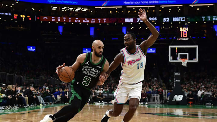 Apr 2, 2025; Boston, Massachusetts, USA; Boston Celtics guard Derrick White (9) controls the ball while Miami Heat guard Alec Burks (18) defends during the second half at TD Garden. Mandatory Credit: Bob DeChiara-Imagn Images
