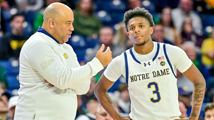Mar 8, 2025; South Bend, Indiana, USA; Notre Dame Fighting Irish head coach Micah Shrewsberry talks to guard Markus Burton (3) in the first overtime period against the Cal Bears at the Purcell Pavilion. Mandatory Credit: Matt Cashore-Imagn Images Mar 8, 2025; South Bend, Indiana, USA; Notre Dame Fighting Irish head coach Micah Shrewsberry talks to guard Markus Burton (3) in the first overtime period against the Cal Bears at the Purcell Pavilion. Mandatory Credit: Matt Cashore-Imagn Images