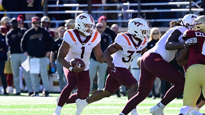Nov 11, 2023; Chestnut Hill, Massachusetts, USA; Virginia Tech Hokies quarterback Kyron Drones (1) runs the ball  during the first half against the Boston College Eagles at Alumni Stadium. Mandatory Credit: Eric Canha-Imagn Images