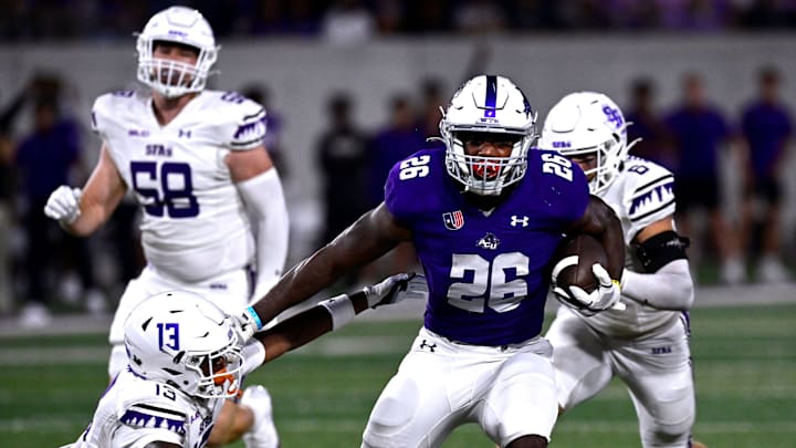 ACU running back Jordon Vaughn stiff-arms SFA cornerback Aaron Sears as he carries the ball downfield for an eventual touchdown Saturday Sept. 6, 2025. Abilene Christian University defeated Stephen F. Austin University at home, 28-20.