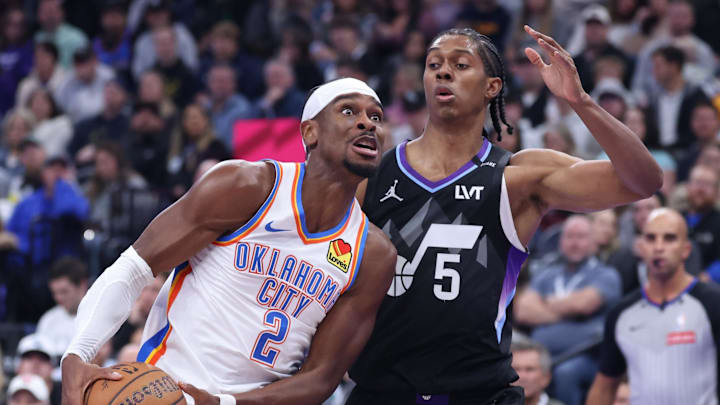 Nov 21, 2025; Salt Lake City, Utah, USA; Oklahoma City Thunder guard Shai Gilgeous-Alexander (2) drives against Utah Jazz forward Cody Williams (5) during the first half at Delta Center. Mandatory Credit: Rob Gray-Imagn Images