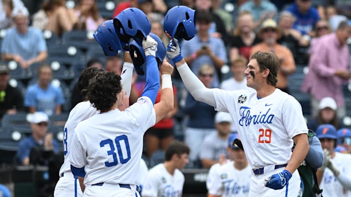Jun 19, 2024; Omaha, NE, USA;  Florida Gators designated hitter Brody Donay (29) celebrates hitting a grand slam with right fielder Ashton Wilson (30) against the Kentucky Wildcats during the first inning at Charles Schwab Field Omaha. Mandatory Credit: Steven Branscombe-Imagn Images