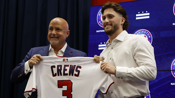 Jul 22, 2023; Washington, District of Columbia, USA; Washington Nationals president of baseball operations and general manager Mike Rizzo (L) and Nationals first round draft pick outfielder Dylan Crews (R) hold Crews' jersey at an introductory press conference prior to the Nationals' game against the San Francisco Giants at Nationals Park.