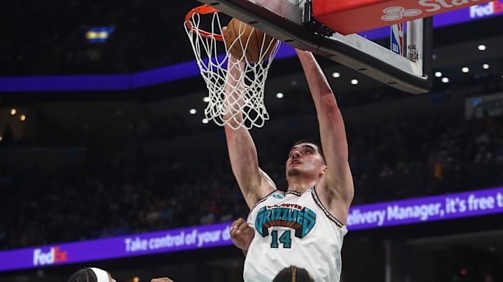 Apr 18, 2025; Memphis, Tennessee, USA; Memphis Grizzlies center Zach Edey (14) dunks during the fourth quarter against the Dallas Mavericks at FedExForum. Mandatory Credit: Petre Thomas-Imagn Images
