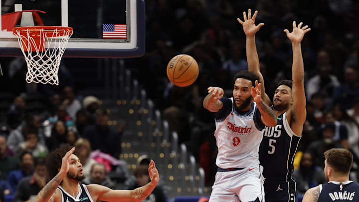 Dec 5, 2024; Washington, District of Columbia, USA; Washington Wizards forward Justin Champagnie (9) leaps to pass the ball as Washington Wizards guard Jaylen Nowell (5) defends in the second quarter at Capital One Arena. Mandatory Credit: Geoff Burke-Imagn Images