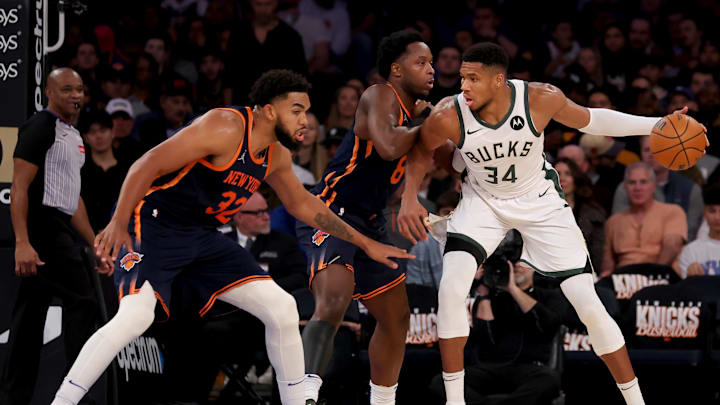 Nov 8, 2024; New York, New York, USA; Milwaukee Bucks forward Giannis Antetokounmpo (34) controls the ball against New York Knicks forward OG Anunoby (8) and center Karl-Anthony Towns (32) during the third quarter at Madison Square Garden. Mandatory Credit: Brad Penner-Imagn Images