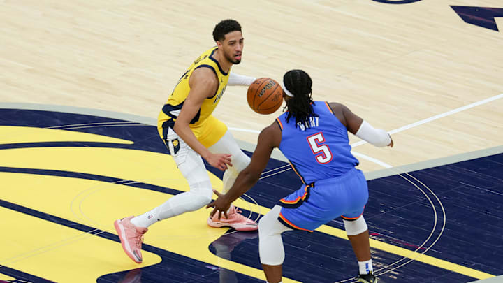 Jun 19, 2025; Indianapolis, Indiana, USA; Indiana Pacers guard Tyrese Haliburton (0) dribbles the ball defended by Oklahoma City Thunder guard Luguentz Dort (5) in the second quarter during game six of the 2025 NBA Finals at Gainbridge Fieldhouse. Mandatory Credit: Trevor Ruszkowski-Imagn Images