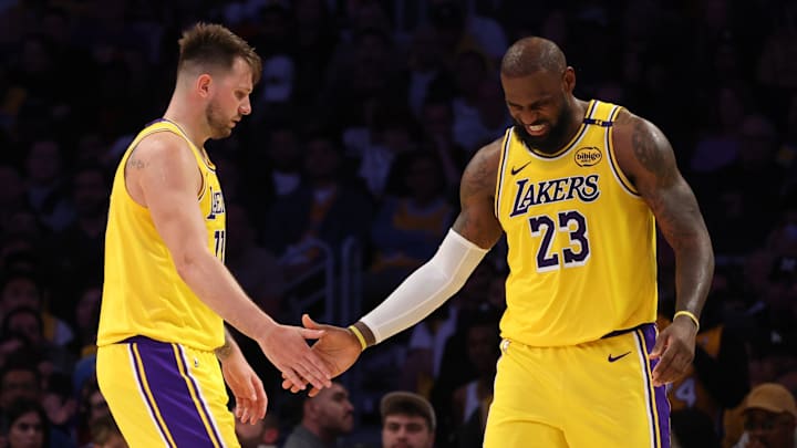 Feb 27, 2025; Los Angeles, California, USA; Los Angeles Lakers guard Luka Doncic (77) and forward LeBron James (23) celebrate after a play during the fourth quarter against the Minnesota Timberwolves at Crypto.com Arena. Mandatory Credit: Jason Parkhurst-Imagn Images