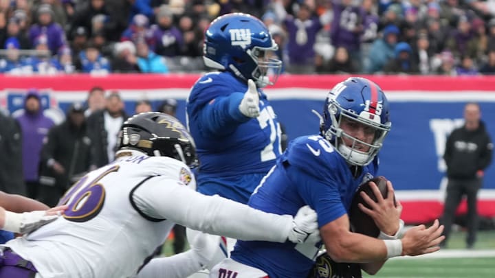 East Rutherford, NJ -- December 15, 2024 -- Michael Pierce of the Ravens hits Tommy DeVito of the Giants, taking a late hit penalty in the first half. The Baltimore Ravens came to MetLife Stadium to play the New York Giants.
