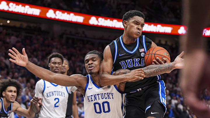 Nov 12, 2024; Atlanta, Georgia, USA; Duke Blue Devils guard Caleb Foster (1) is defended by Kentucky Wildcats guard Otega Oweh (00) during the second half at State Farm Arena. Mandatory Credit: Dale Zanine-Imagn Images