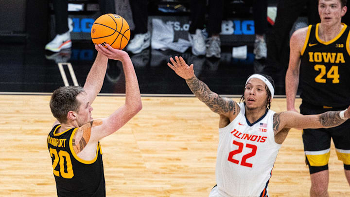 Mar 13, 2025; Indianapolis, IN, USA; Iowa Hawkeyes forward Payton Sandfort (20) shoots the ball while Illinois Fighting Illini guard Tre White (22) defends in the first half at Gainbridge Fieldhouse. Mandatory Credit: Trevor Ruszkowski-Imagn Images