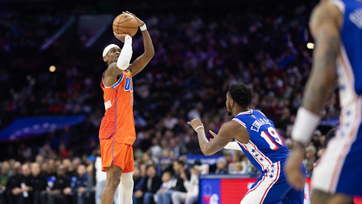 Jan 14, 2025; Philadelphia, Pennsylvania, USA; Oklahoma City Thunder guard Shai Gilgeous-Alexander (2) shoots in front of Philadelphia 76ers forward Justin Edwards (19) during the third quarter at Wells Fargo Center. Mandatory Credit: Bill Streicher-Imagn Images Jan 14, 2025; Philadelphia, Pennsylvania, USA; Oklahoma City Thunder guard Shai Gilgeous-Alexander (2) shoots in front of Philadelphia 76ers forward Justin Edwards (19) during the third quarter at Wells Fargo Center. Mandatory Credit: Bill Streicher-Imagn Images