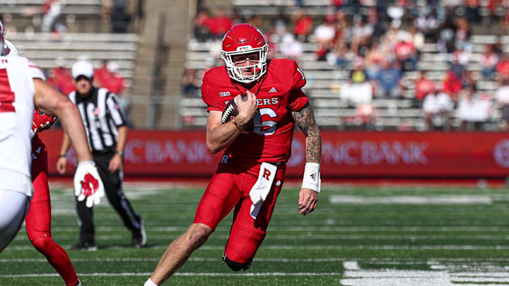 Oct 12, 2024; Piscataway, New Jersey, USA; Rutgers Scarlet Knights quarterback Athan Kaliakmanis (16) carries the ball against the Wisconsin Badgers pursues during the second half at SHI Stadium. Mandatory Credit: Vincent Carchietta-Imagn Images Oct 12, 2024; Piscataway, New Jersey, USA; Rutgers Scarlet Knights quarterback Athan Kaliakmanis (16) carries the ball against the Wisconsin Badgers pursues during the second half at SHI Stadium. Mandatory Credit: Vincent Carchietta-Imagn Images