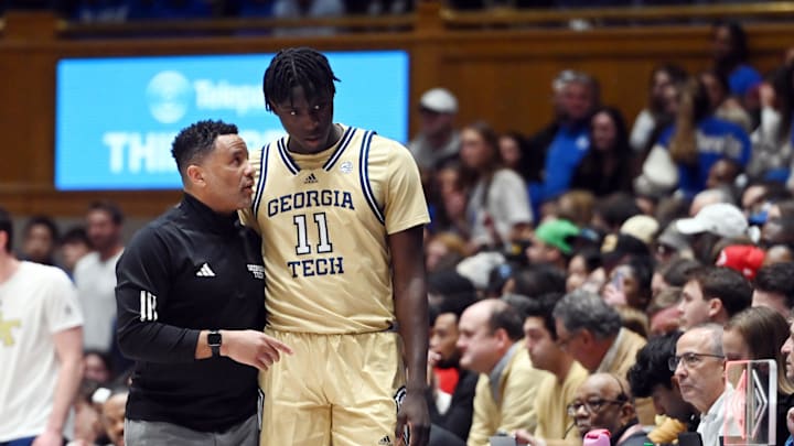 Jan 13, 2024; Durham, North Carolina, USA; Georgia Tech Yellow Jackets head coach Damon Stoudamire (left) talks to forward Baye Ndongo (11) during the first half against the Duke Blue Devils at Cameron Indoor Stadium. Mandatory Credit: Rob Kinnan-Imagn Images