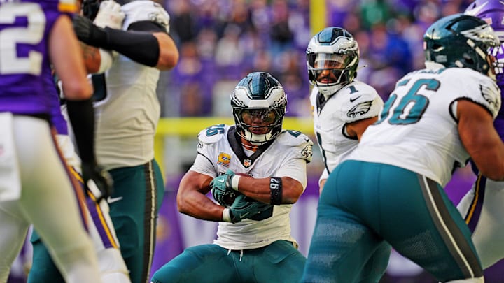 Oct 19, 2025; Minneapolis, Minnesota, USA; Philadelphia Eagles running back Saquon Barkley (26) protects the ball during the second half against the Minnesota Vikings at U.S. Bank Stadium. Mandatory Credit: Brad Rempel-Imagn Images