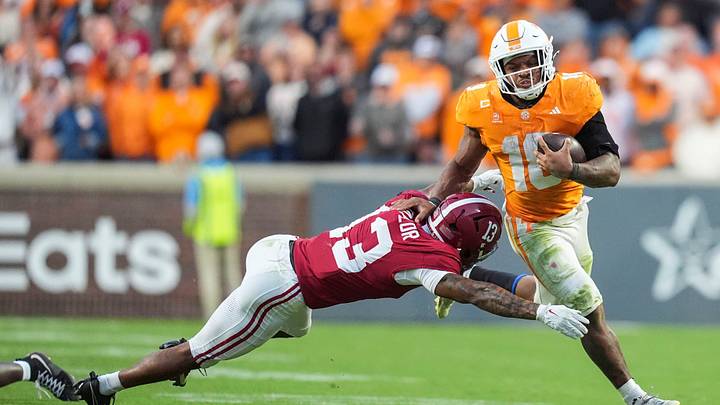 Tennessee running back DeSean Bishop (18) escapes the tackle from Alabama defensive back Ivan Taylor (13) during a football game between Tennessee and Alabama at Neyland Stadium in Knoxville, Tenn., on Oct. 17, 2026. Tennessee running back DeSean Bishop (18) escapes the tackle from Alabama defensive back Ivan Taylor (13) during a football game between Tennessee and Alabama at Neyland Stadium in Knoxville, Tenn., on Oct. 17, 2026.
