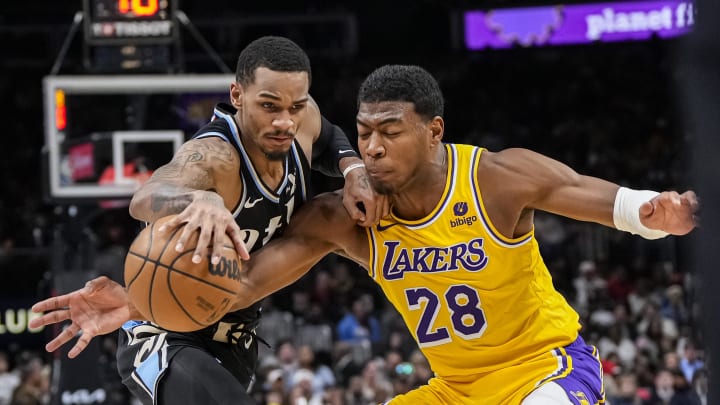 Jan 30, 2024; Atlanta, Georgia, USA; Atlanta Hawks guard Dejounte Murray (5) is defended by Los Angeles Lakers forward Rui Hachimura (28) during the second half at State Farm Arena. Mandatory Credit: Dale Zanine-USA TODAY Sports