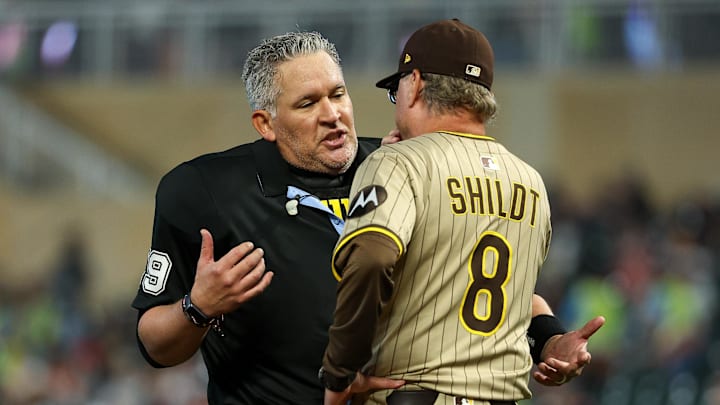 Aug 29, 2025; Minneapolis, Minnesota, USA; San Diego Padres manager Mike Shildt (8) talks with umpire Manny Gonzalez (79) during the fourth inning against the Minnesota Twins at Target Field. Mandatory Credit: Matt Krohn-Imagn Images