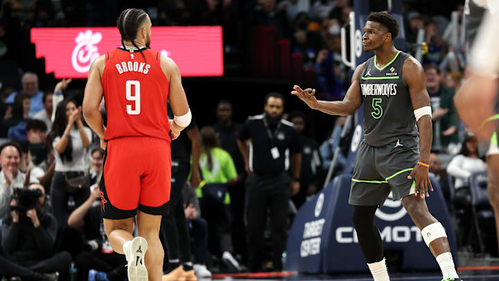 Feb 6, 2025; Minneapolis, Minnesota, USA; Minnesota Timberwolves guard Anthony Edwards (5) celebrates his three-point basket towards Houston Rockets forward Dillon Brooks (9) during the fourth quarter at Target Center. Mandatory Credit: Matt Krohn-Imagn Images