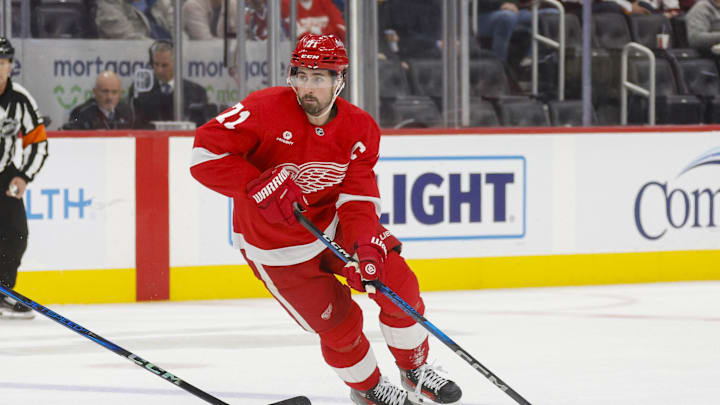 Dec 7, 2024; Detroit, Michigan, USA; Detroit Red Wings center Dylan Larkin (71) handles the puck against the Colorado Avalanche during the second period at Little Caesars Arena. Mandatory Credit: Brian Bradshaw Sevald-Imagn Images