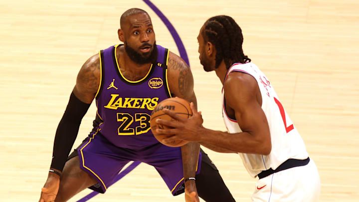 Feb 28, 2025; Los Angeles, California, USA; Los Angeles Lakers forward LeBron James (23) defends LA Clippers forward Kawhi Leonard (2) during the first quarter at Crypto.com Arena. Mandatory Credit: Jason Parkhurst-Imagn Images
