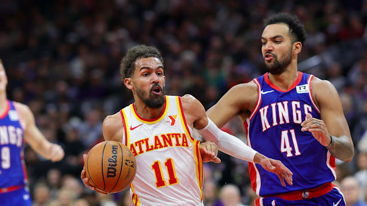 Nov 18, 2024; Sacramento, California, USA; Atlanta Hawks guard Trae Young (11) drives to the basket against Sacramento Kings forward Trey Lyles (41) during the second quarter at Golden 1 Center. Mandatory Credit: Sergio Estrada-Imagn Images