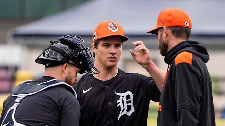 Detroit Tigers pitcher Jackson Jobe, center, talks to j, left, and pitching coach Chris Fetter during spring training at Joker Marchant Stadium in Lakeland, Fla. on Thursday, Feb. 20, 2025.