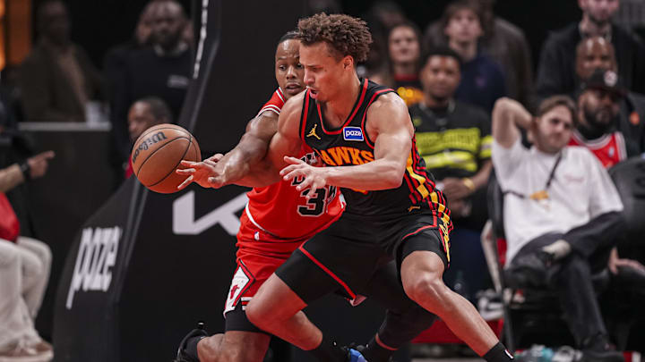 Dec 21, 2025; Atlanta, Georgia, USA; Chicago Bulls forward Isaac Okoro (35) and Atlanta Hawks guard Dyson Daniels (5) fight for the ball during the second half at State Farm Arena. Mandatory Credit: Dale Zanine-Imagn Images