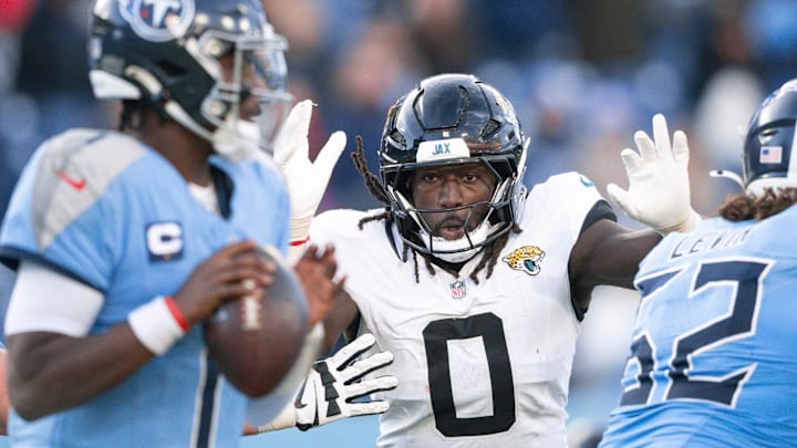 Nov 30, 2025; Nashville, Tennessee, USA;  Jacksonville Jaguars linebacker Devin Lloyd (0) rushes Tennessee Titans quarterback Cameron Ward (1) during the second half at Nissan Stadium. Mandatory Credit: Steve Roberts-Imagn Images