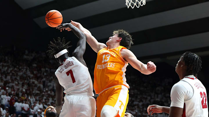 Jan 24, 2026; Tuscaloosa, Alabama, USA; Alabama Crimson Tide forward Taylor Bol Bowen (7) rebounds against Tennessee Volunteers forward J.P. Estrella (13) during the first half at Coleman Coliseum. Mandatory Credit: David Leong-Imagn Images