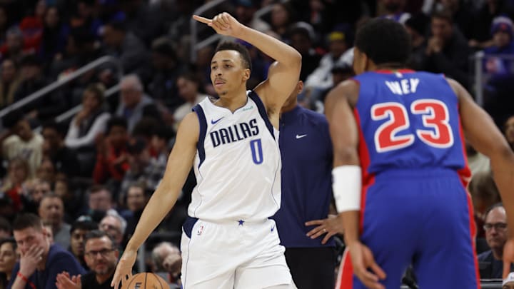 Mar 9, 2024; Detroit, Michigan, USA;  Dallas Mavericks guard Dante Exum (0) dribbles against Detroit Pistons guard Jaden Ivey (23) in the first half at Little Caesars Arena. Mandatory Credit: Rick Osentoski-Imagn Images