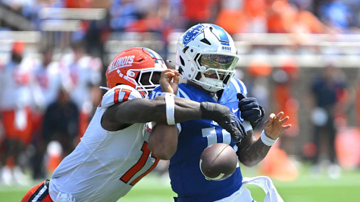 Sep 6, 2025; Durham, North Carolina, USA;  Illinois Fighting Illini linebacker Gabe Jacas (17) swats the ball from Duke Blue Devils quarterback Darian Mensah (10) during the second quarter at Wallace Wade Stadium. Mandatory Credit: Zachary Taft-Imagn Images