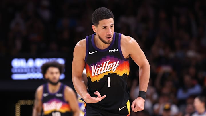 Phoenix Suns guard Devin Booker celebrates after making a shot against the Indiana Pacers. Phoenix Suns guard Devin Booker celebrates after making a shot against the Indiana Pacers.